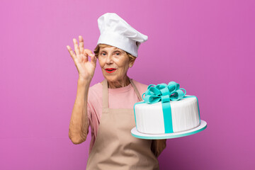 mature beautiful old woman feeling happy, relaxed and satisfied, showing approval with okay gesture, smiling