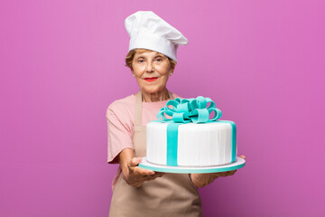 mature beautiful old woman smiling happily with friendly, confident, positive look, offering and showing an object or concept