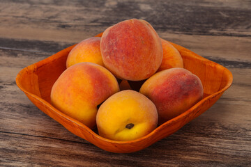 Peach heap in the wooden basket