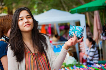 Teen girl shopping outdoor bazaar in Thailand