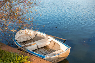 The rescue boat was moored to the shore of the pond. The concept of saving water