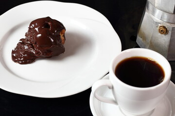 Coffee cup and single cream puff