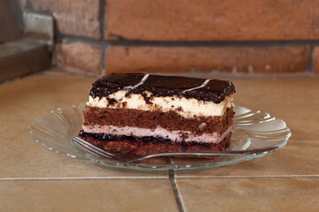 Layer cake with fruit and cream fillings decorated chocolate icing