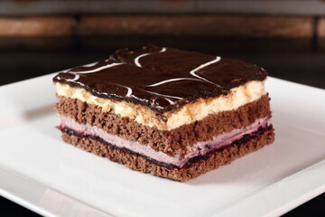 Layer cake with fruit and cream fillings decorated chocolate icing