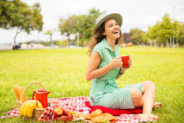 Beautiful young woman having picnic.