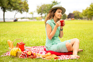 Beautiful young woman having picnic.