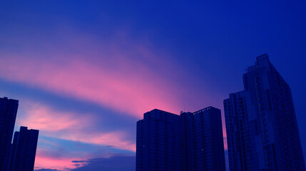 Pop art surreal style vibrant blue and pink colored city at sunset - obrazy, fototapety, plakaty