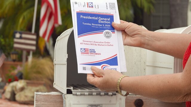 Close up of American mail ballot and voter booklet taken from post box. Illustrative editorial taken in Vista, CA / USA on October 6, 2020.