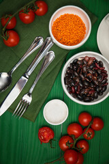The dishes are laid out on a wooden table. Cherry, grass, utensils, sea salt
