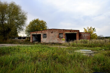 old abandoned building overgrown with grass