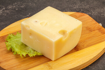 Emmental cheese over wooden board