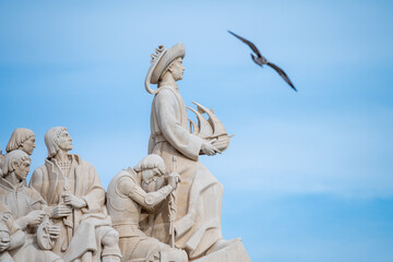 view of the seagull passing by the pattern of discoveries in Lisbon