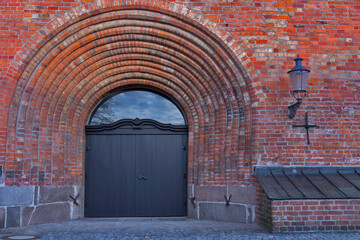 An old lamp and a big door from a church