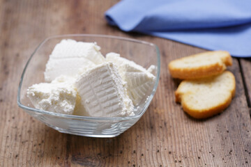 Ricotta cheese on wood background