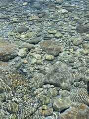 Picturesque pebble and stones in crystal clear sea water
