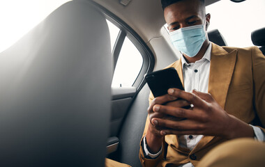 Young Businessman Wearing Mask Checking Mobile Phone In Back Of Taxi During Health Pandemic