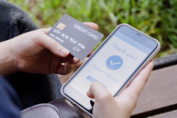 Online shopping, mobile payment. Woman hands holding credit card and using smart phone for online payment