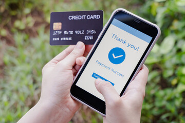 Online shopping, mobile payment. Woman hands holding credit card and using smart phone for online payment