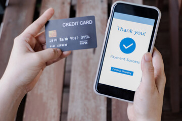 Online shopping, mobile payment. Woman hands holding credit card and using smart phone for online payment