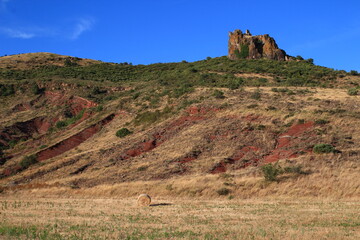 Evening is about to fall on the red stone and the ruins of the Malavieille castle (Mérifons,...