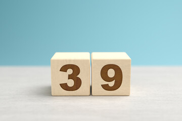 Wooden toy blocks forming the number 39.