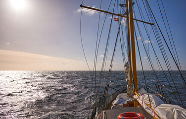 Sailing old schooner at sunset, travel and adventure concept,