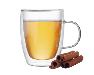 Glass cup of tea and cinnamon sticks isolated on white