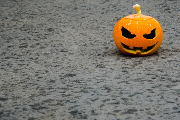 
In the upper right corner, on a dark overhang, is an orange Halloween pumpkin. background blurred