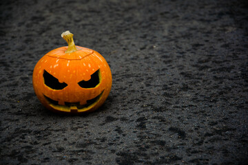 Halloween pumpkin on a dark background with a blurred background.