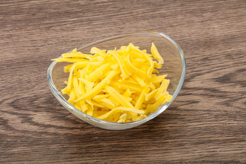 Shredded yellow cheese in the bowl