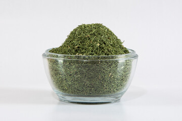 a glass bowl of dried dill