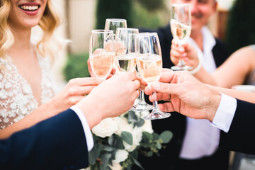 Party with friends. Group of cheerful young people carrying sparklers and champagne flutes