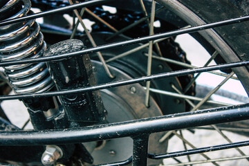 Fototapeta na wymiar Closeup of a motorcycle parked in the streets of the city center of the metropolitan area 