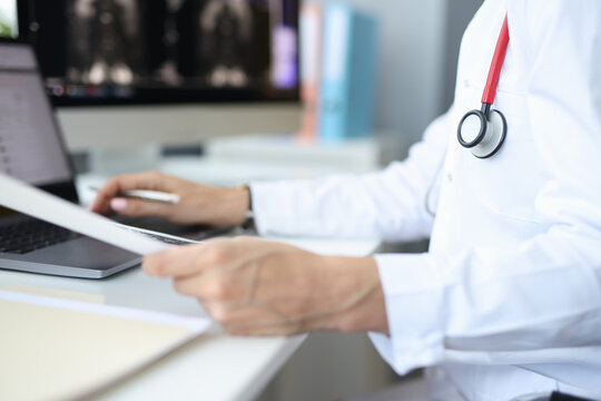 Medical officer at workplace in the office works at computer. Medical statistics on diseases concept