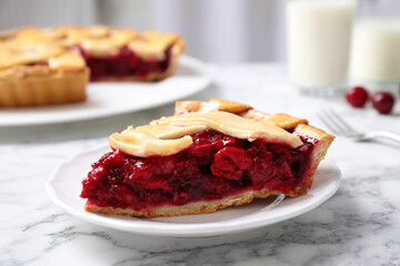 Slice of delicious fresh cherry pie on white marble table, closeup