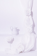 Fototapeta na wymiar Fashion winter scene. Tea pot, roses and textile decor. Minimal stylish white colours design
