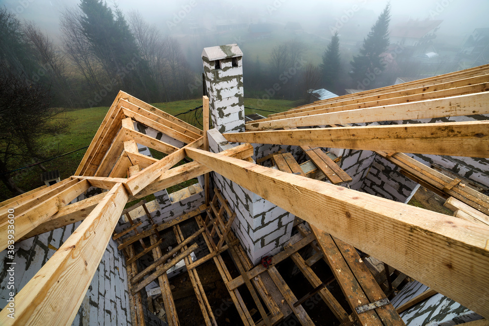 Wall mural top view of roof frame from wooden lumber beams and planks on walls made of hollow foam insulation b