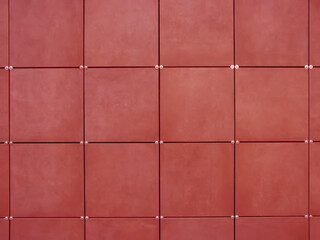 Fototapeta na wymiar Background of wall made of red square tiles