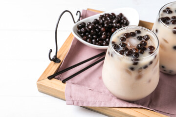 Bubble milk tea with tapioca balls on wooden tray