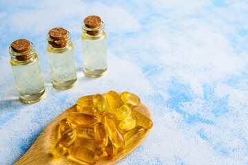 Fish oil capsules on a blue background - omega 3 vitamins and health concept