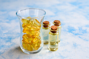 Fish oil capsules on a blue background - omega 3 vitamins and health concept