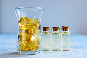 Fish oil capsules on a blue background - omega 3 vitamins and health concept
