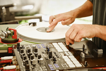 DJ plays on white record with his hands