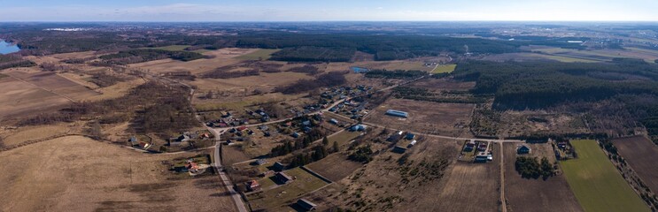 Farm in early spring forest photographed from above