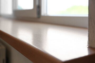 Closeup of plastic window with wooden sill