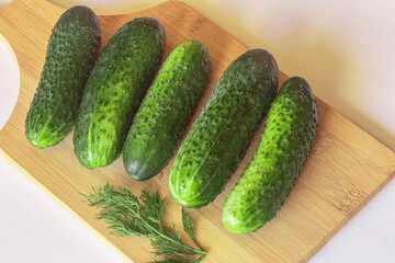Fresh cucumbers on a cutting board. Fresh produce from the Farmers Market.