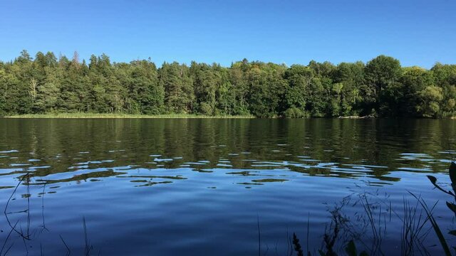 A nice view over dark calm water. A part of the Swedish lake Malar och Malaren. Which is next to the Baltic sea. Jarfalla, Stockholm, Sweden.