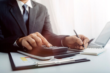 businesswoman hand using smart phone, tablet payments and holding credit card online shopping, omni channel, digital tablet docking keyboard computer at office in sun light