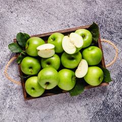 Fototapeta na wymiar Ripe green apples in wooden box.