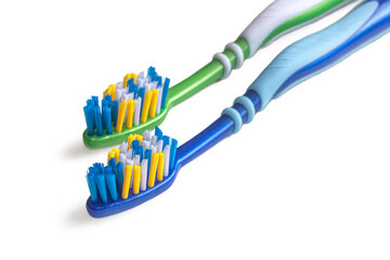 Blue and green toothbrushes, on a white background